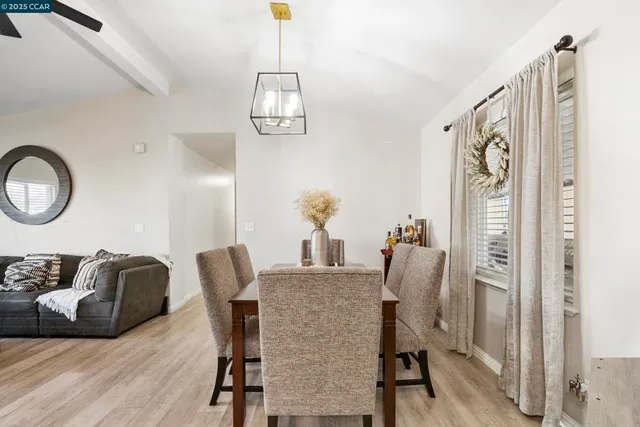 a dining room with furniture and a mirror