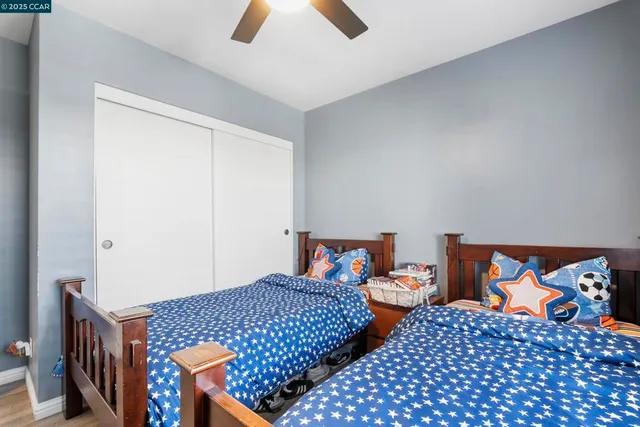 a bedroom with two beds and painted walls