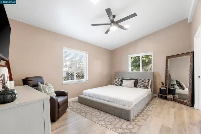 a bedroom with a large bed and a window