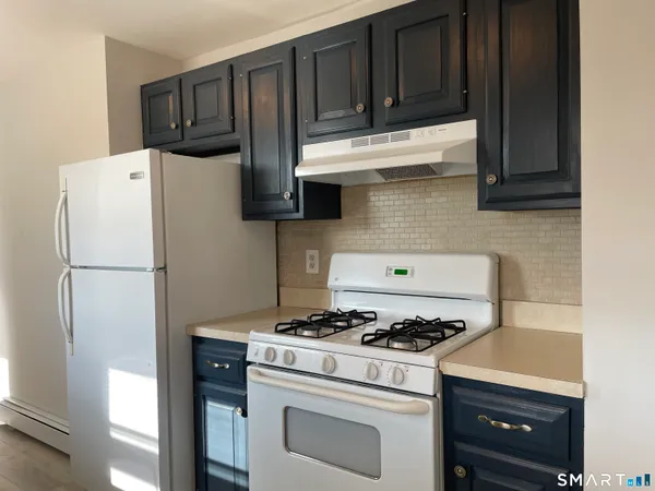 a kitchen with a stove and a refrigerator
