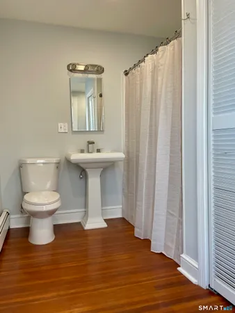 a bathroom with a sink a toilet and mirror