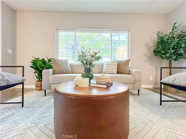 a living room with a bed furniture and a window