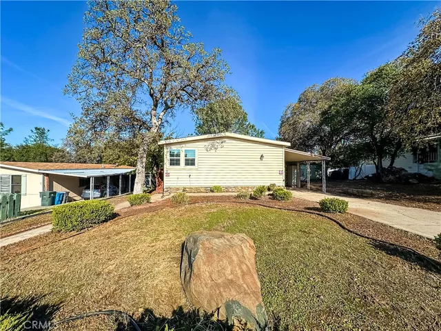 a view of a house with pool and sitting area