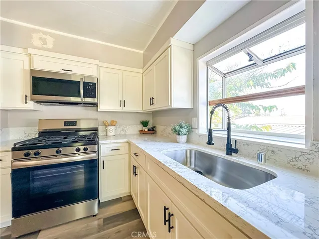 a kitchen with stainless steel appliances white cabinets and a stove