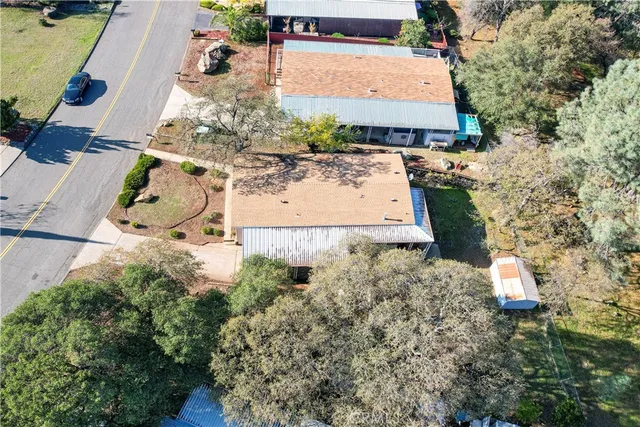 an aerial view of a house with a yard and a fountain