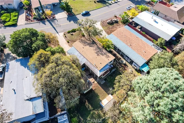 an aerial view of a house with a yard and garden