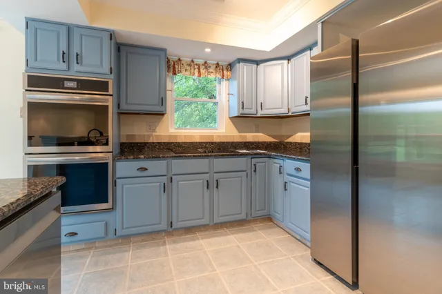 a kitchen with stainless steel appliances a refrigerator and a sink