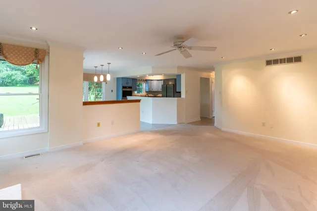 a view of a hallway with wooden floor and stairs