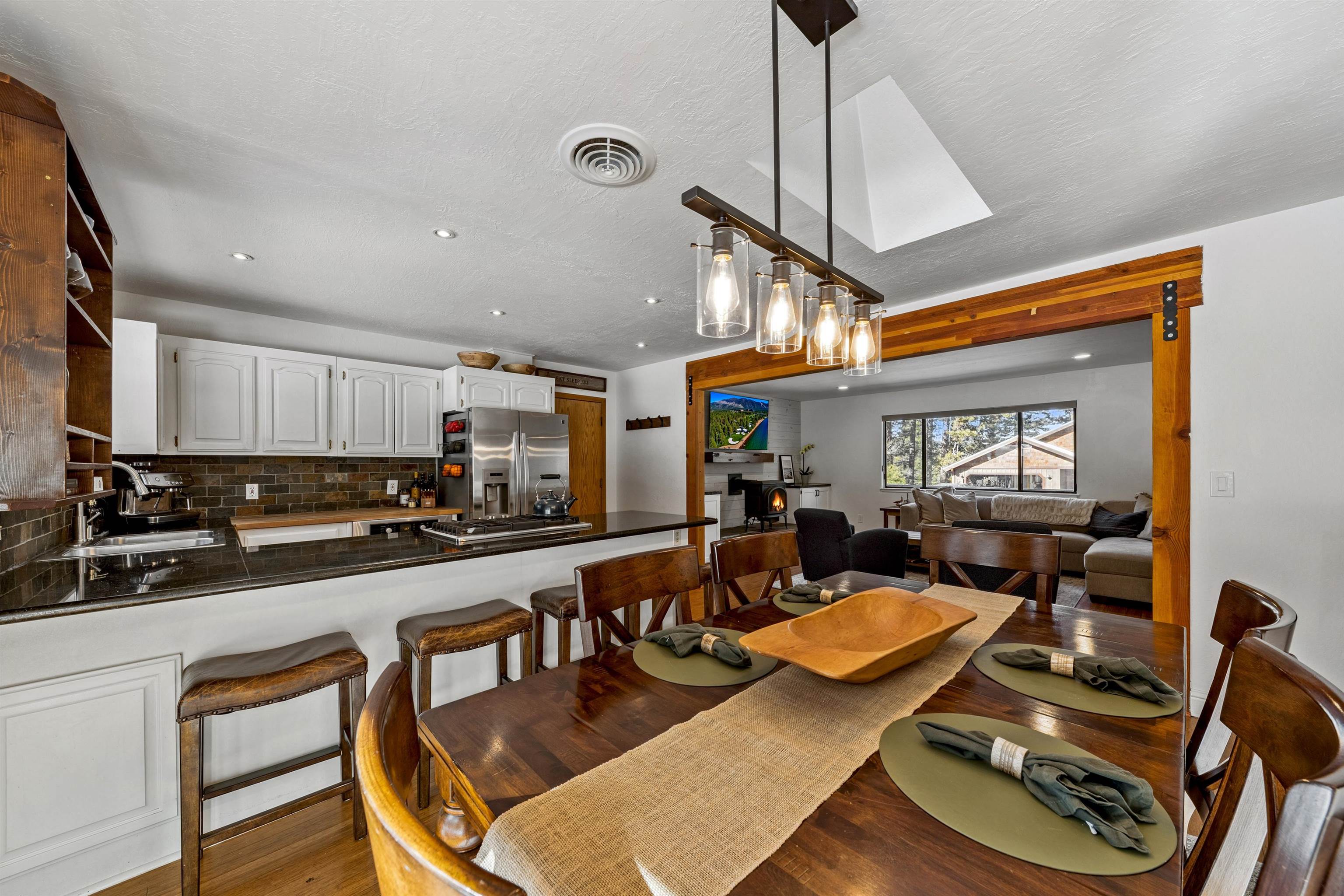 10895 Jeffery Pine Road Truckee, CA 96161 - Photo 15 of 25 a view of a dining room with furniture a chandelier and wooden floor