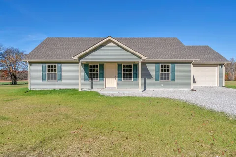a front view of house with yard and green space