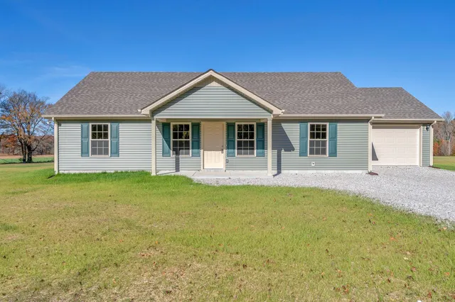 a front view of house with yard and green space