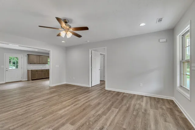 wooden floor in an empty room with a window