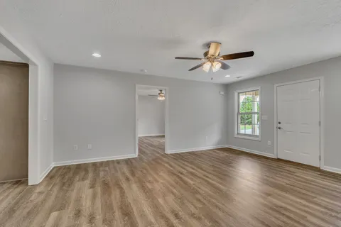 wooden floor in an empty room with a window