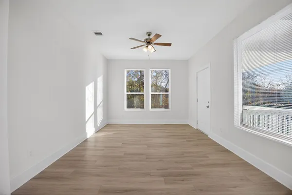 wooden floor in an empty room with a window
