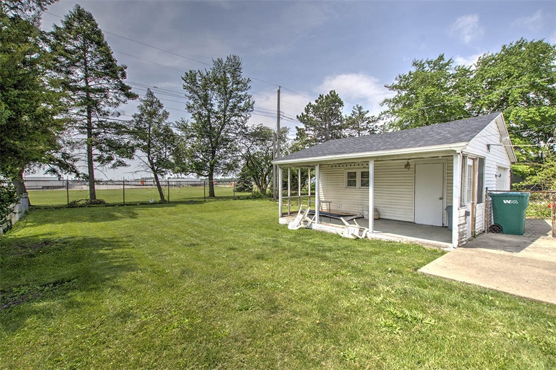 2809 East Cardinal Drive Decatur, IL 62526 - Photo 18 of 20 a large white house with a big yard and large trees