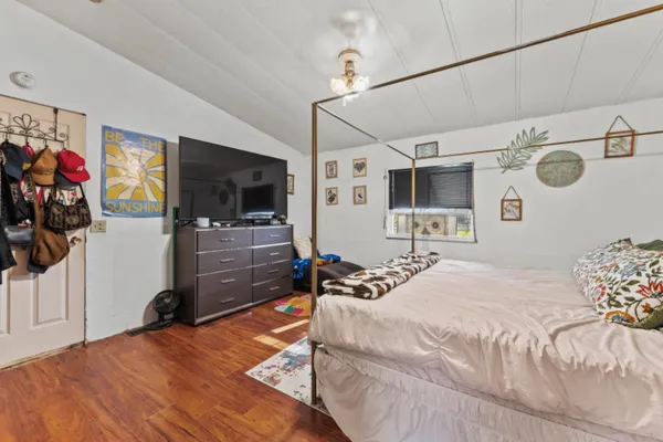 a bedroom with a bed and a flat screen tv