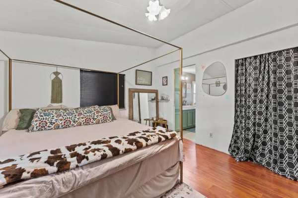 a bedroom with a large bed and a dresser