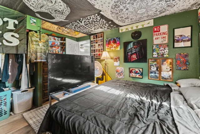 a bed room with a bed and a flat screen tv