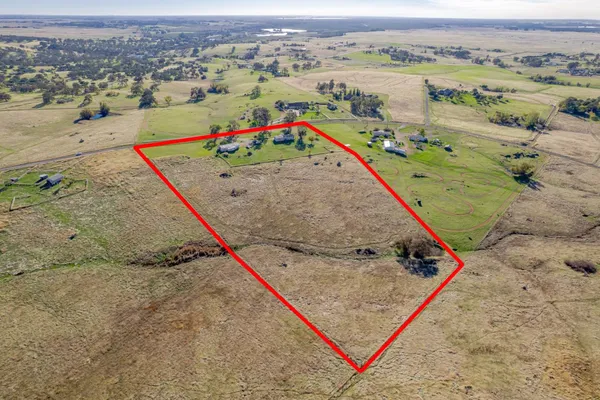 an aerial view of a houses with a swimming pool