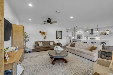 a living room with furniture and a large mirror