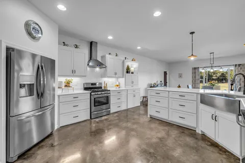 a kitchen with white cabinets and stainless steel appliances
