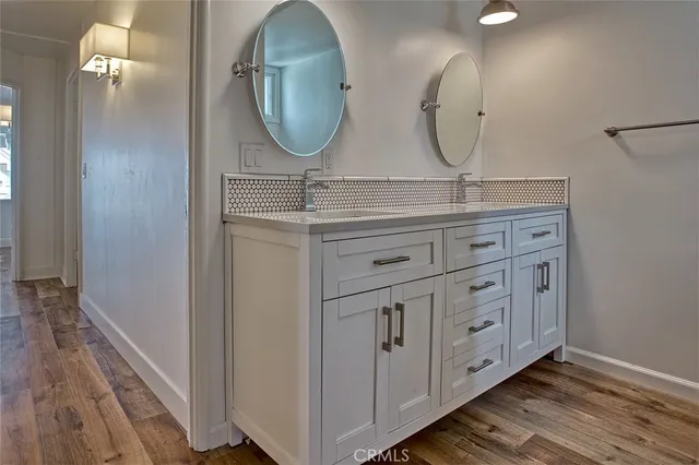 a bathroom with a double vanity sink and a mirror