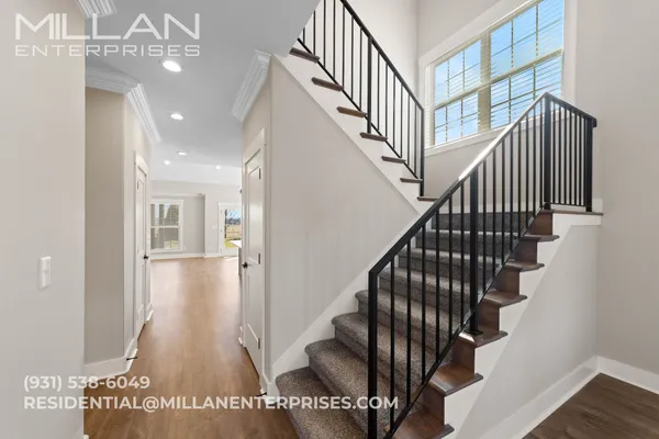 a view of entryway and hall with wooden floor