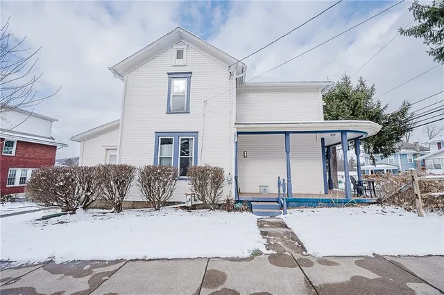 a view of a house with snow on the road