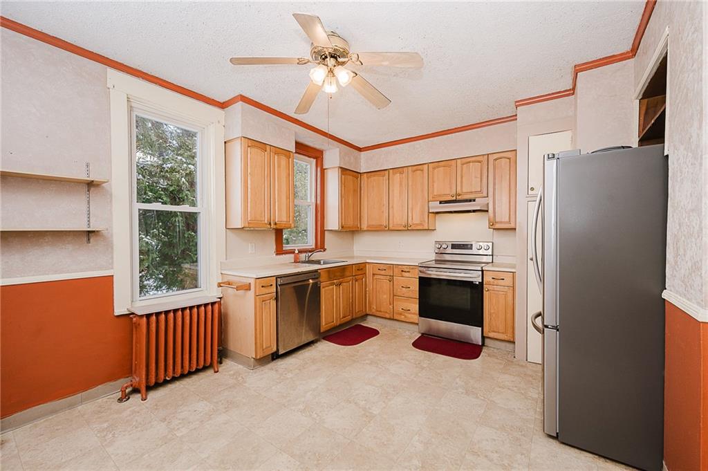 598 South 6th Street Indiana, PA 15701 - Photo 5 of 30 a kitchen with granite countertop a refrigerator a sink a stove and cabinets