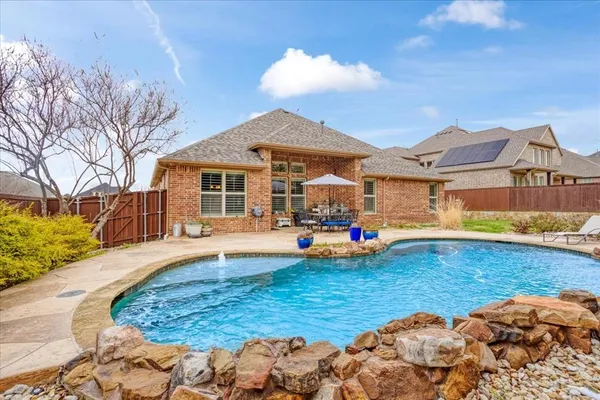 a view of a house with swimming pool and porch