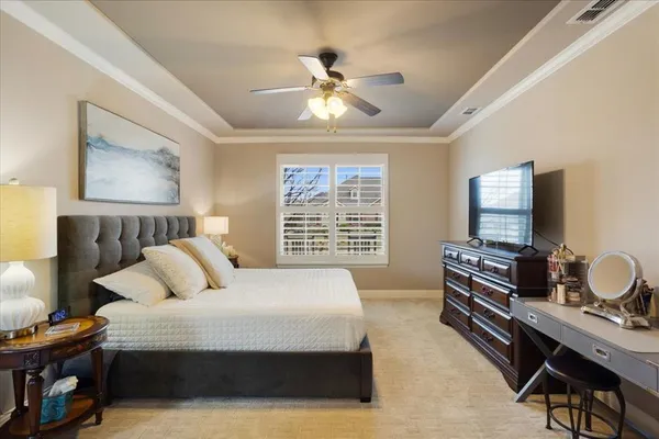 a bedroom with a bed and a desk