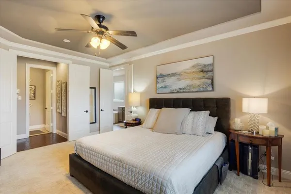 a bedroom with a bed and a chandelier
