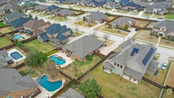 an aerial view of multiple houses with yard