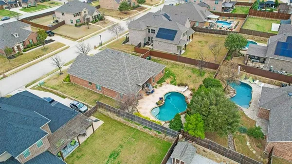 an aerial view of a house with a swimming pool