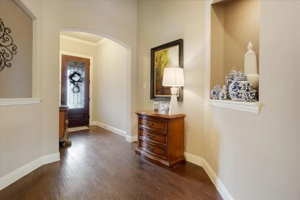 a view of a livingroom with wooden floor and furniture