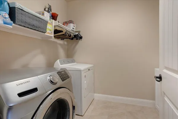 a view of storage and utility room with washer and dryer