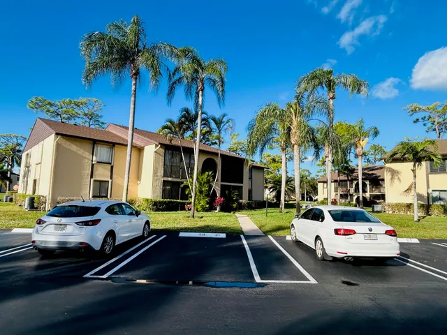 a view of a cars park in front of a house