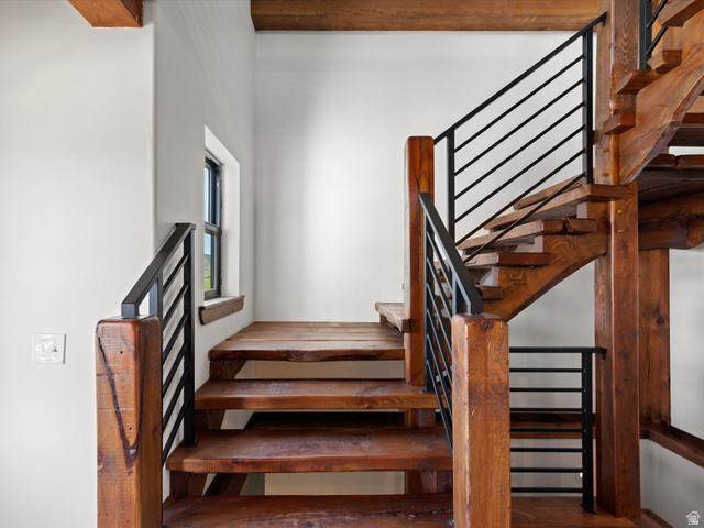 1225 Old Oregon Road Soda Springs, ID 83276 - Photo 32 of 67 Staircase featuring natural wood treads and risers, black metal horizontal railings, and substantial wood newel posts