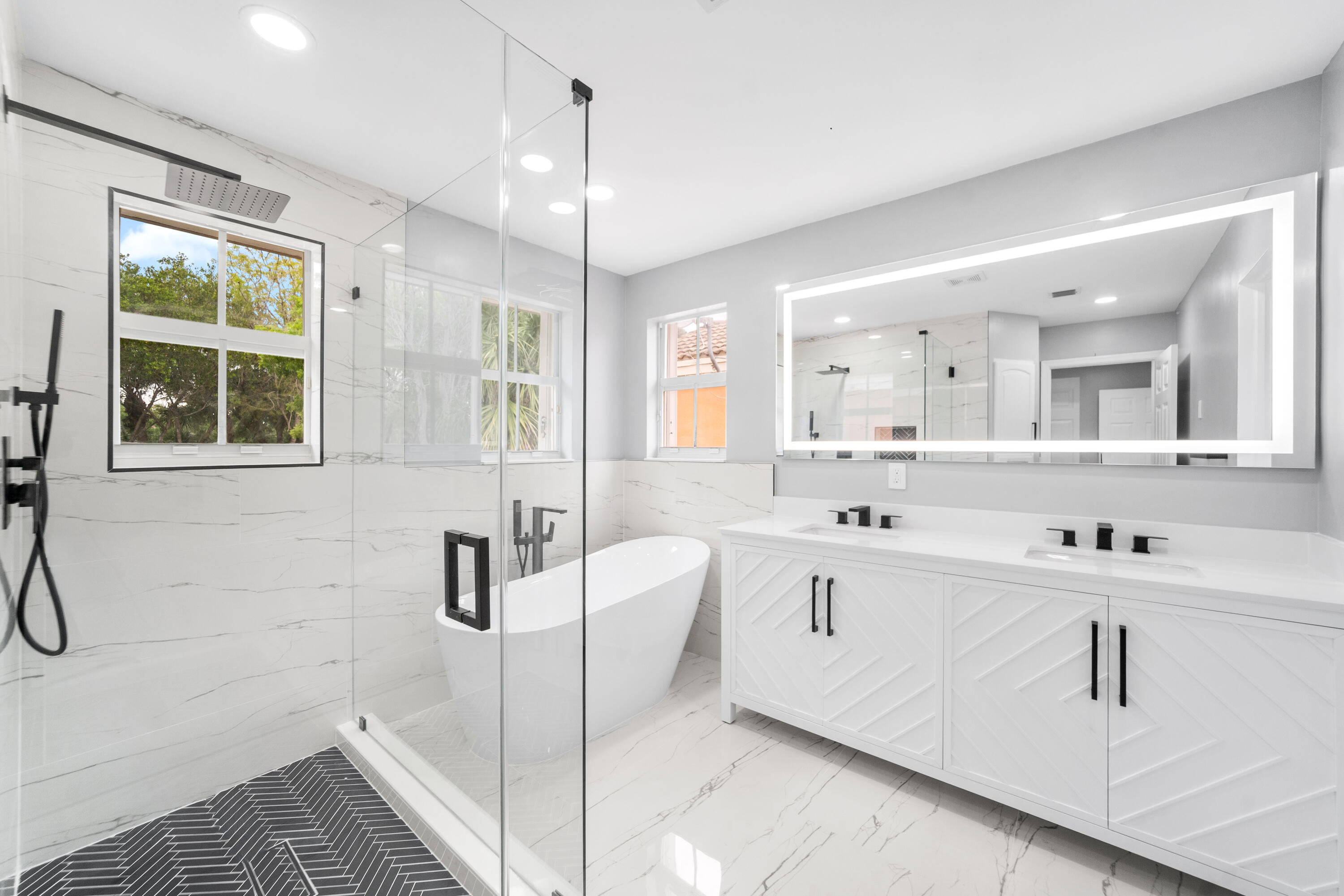 5233 Southwest 155th Way Miramar, FL 33027 - Photo 12 of 63 a spacious bathroom with a double vanity sink a mirror and shower