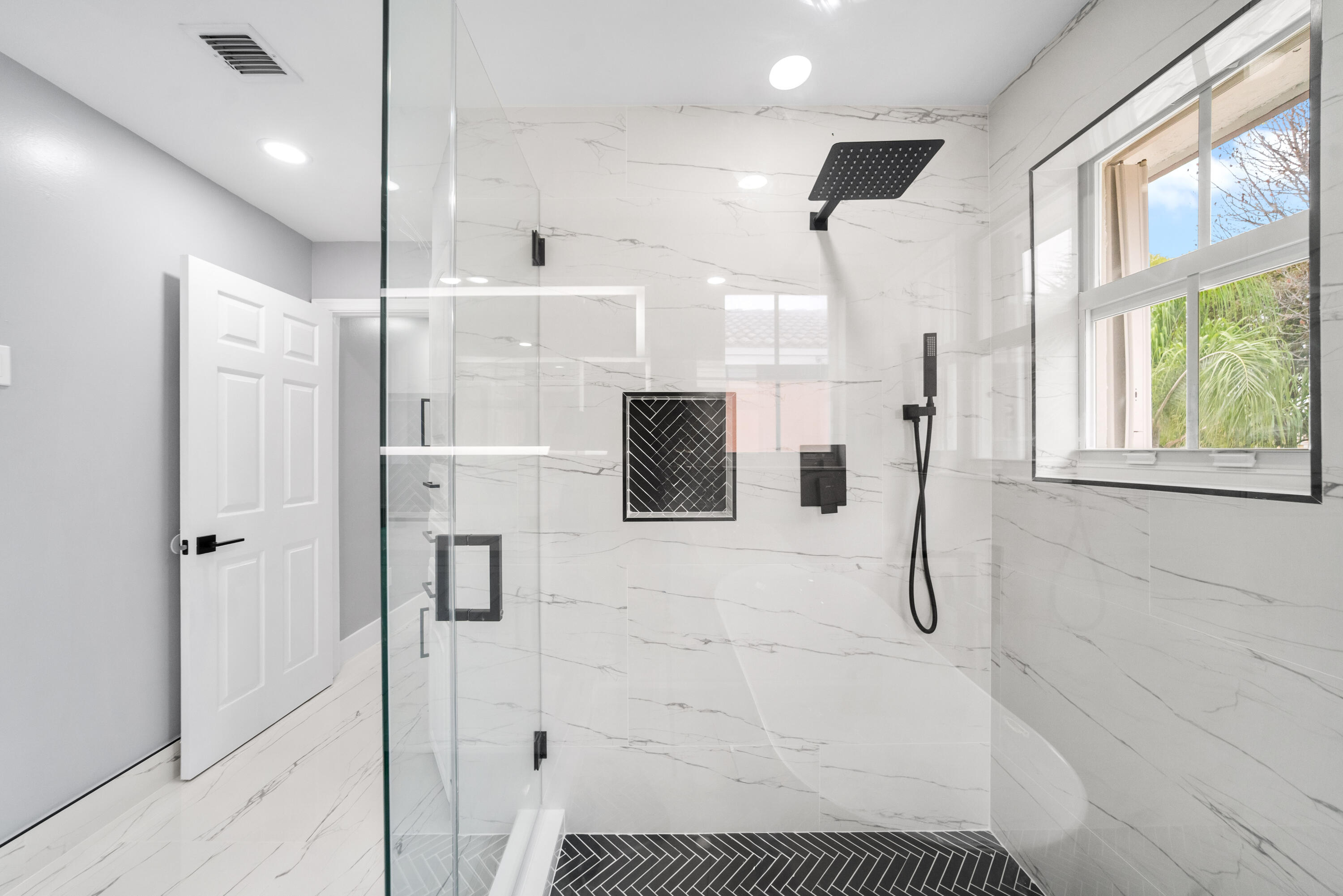 5233 Southwest 155th Way Miramar, FL 33027 - Photo 14 of 63 a bathroom with a shower and a glass door shower