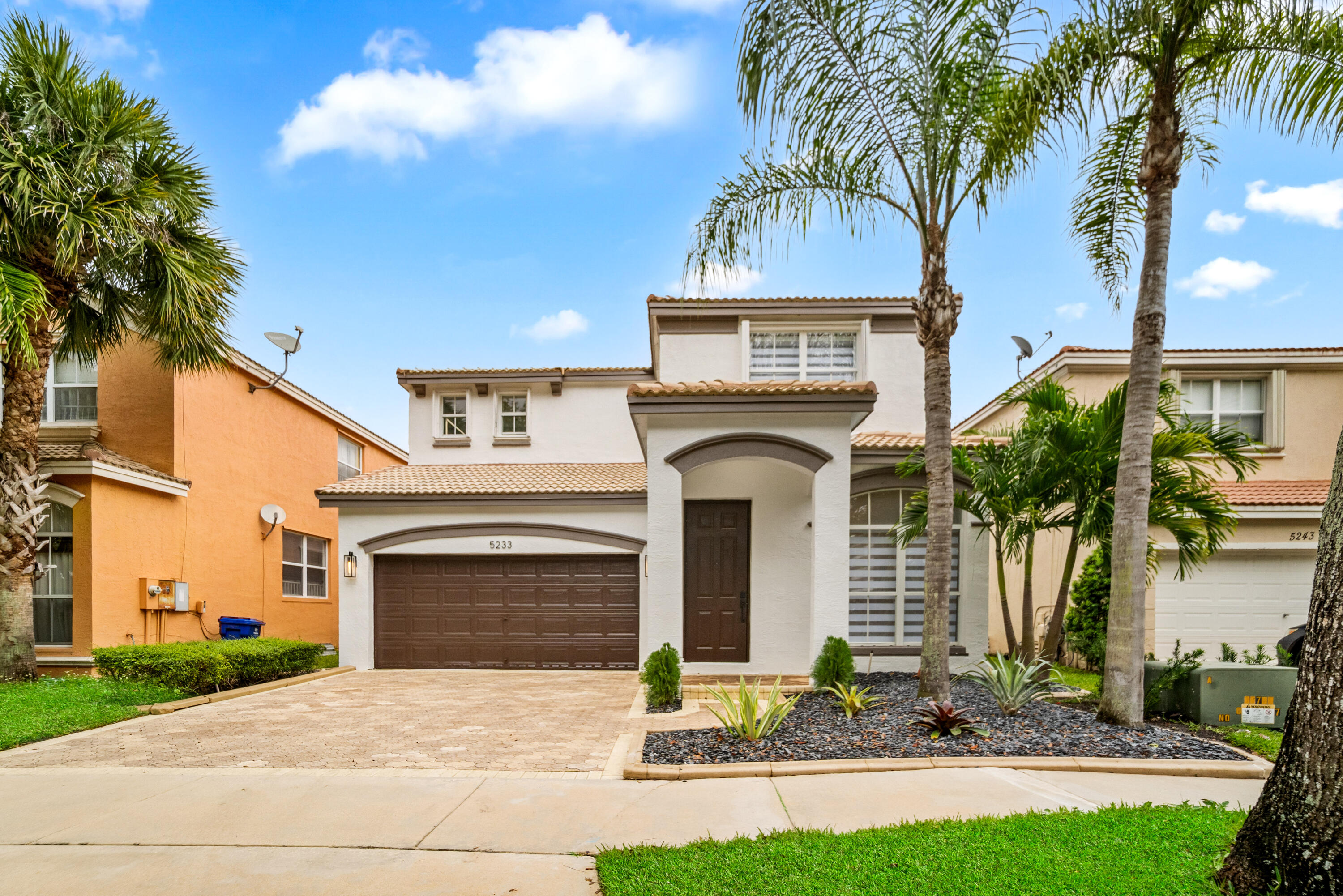 5233 Southwest 155th Way Miramar, FL 33027 - Photo 2 of 63 a front view of a house with garden