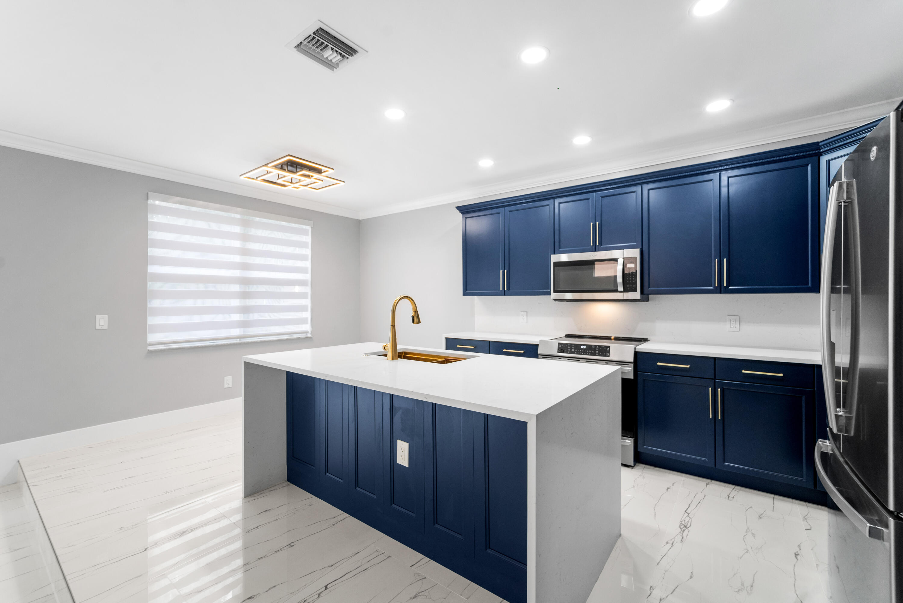 5233 Southwest 155th Way Miramar, FL 33027 - Photo 33 of 63 a kitchen with stainless steel appliances granite countertop wooden cabinets a stove a sink and a refrigerator