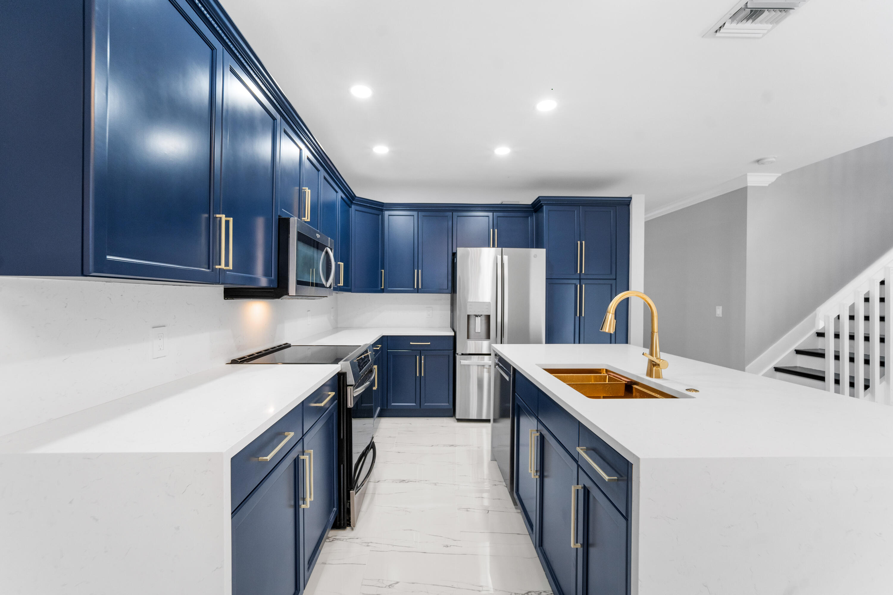 5233 Southwest 155th Way Miramar, FL 33027 - Photo 34 of 63 a kitchen with stainless steel appliances granite countertop a sink a stove and a refrigerator
