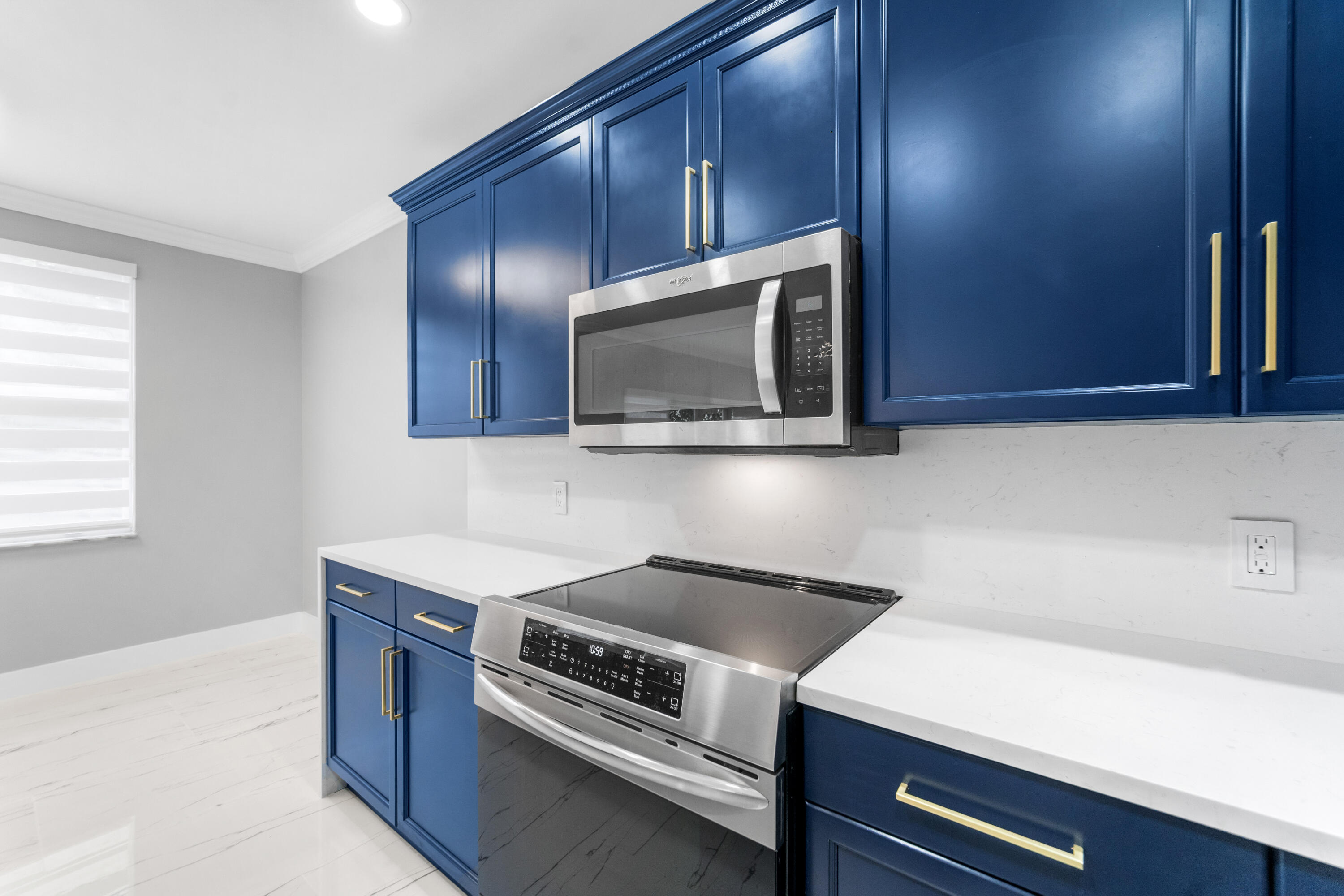 5233 Southwest 155th Way Miramar, FL 33027 - Photo 36 of 63 a kitchen with a stove microwave and sink