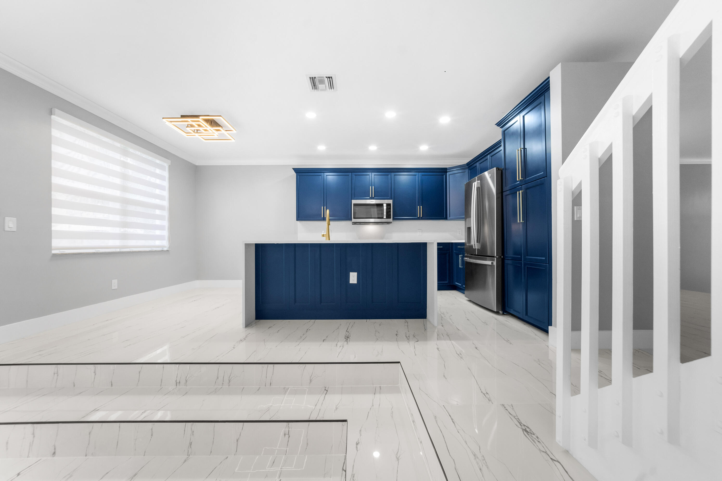 5233 Southwest 155th Way Miramar, FL 33027 - Photo 37 of 63 a kitchen with stainless steel appliances kitchen island granite countertop a refrigerator and a sink