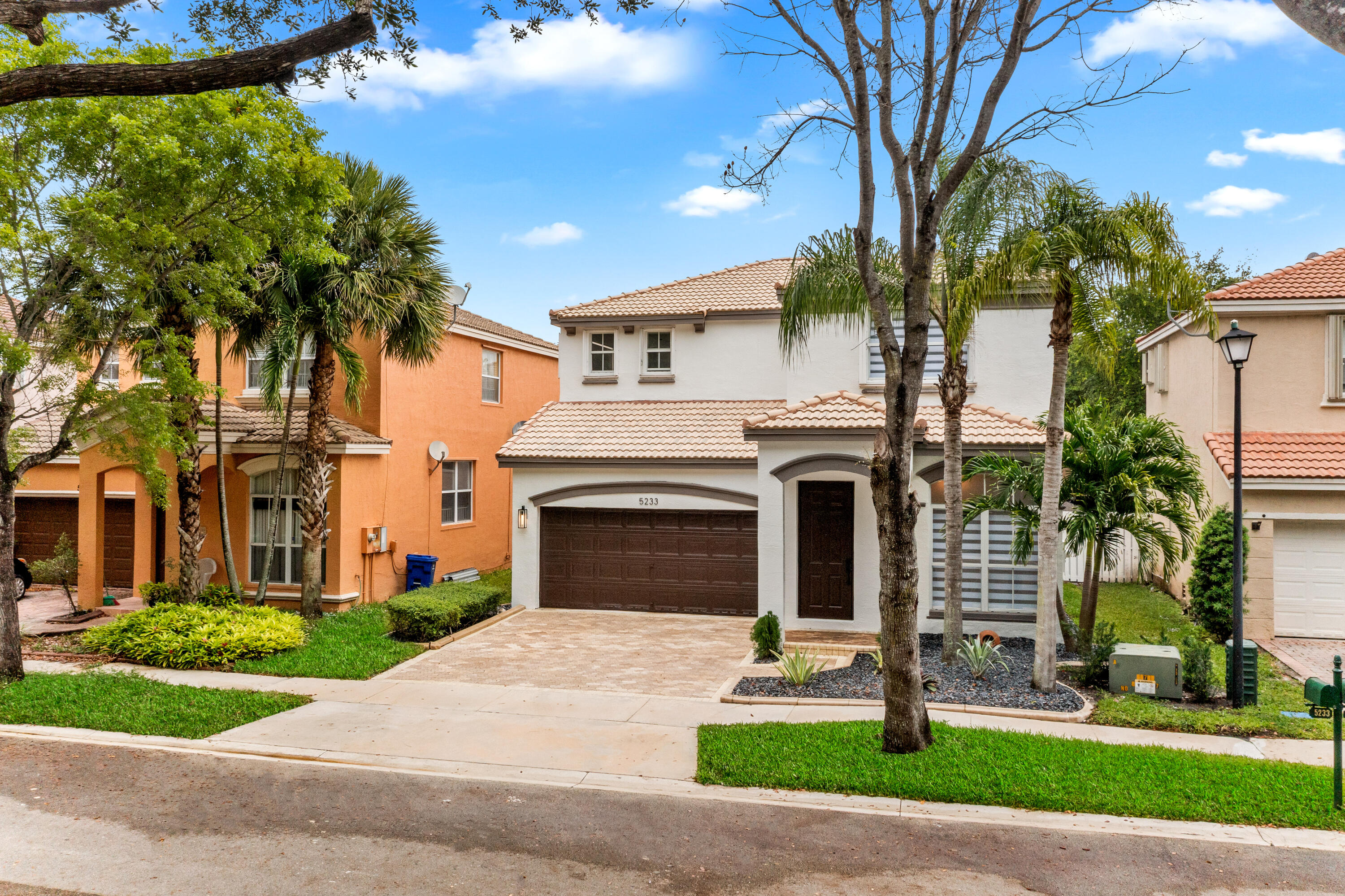 5233 Southwest 155th Way Miramar, FL 33027 - Photo 50 of 63 a front view of a house with a garden and trees
