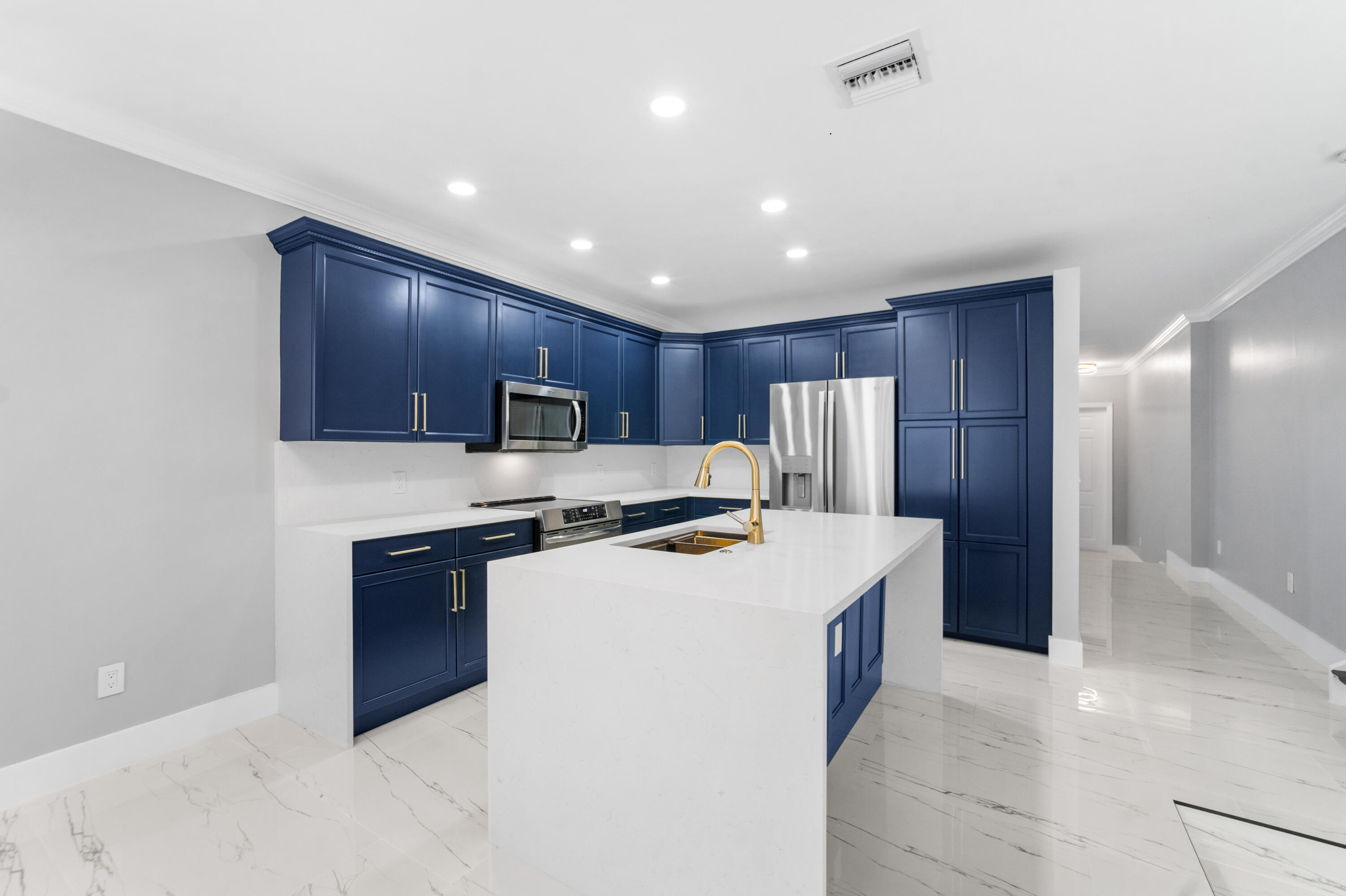 5233 Southwest 155th Way Miramar, FL 33027 - Photo 5 of 63 a kitchen with stainless steel appliances a refrigerator stove a sink and a oven with wooden floor
