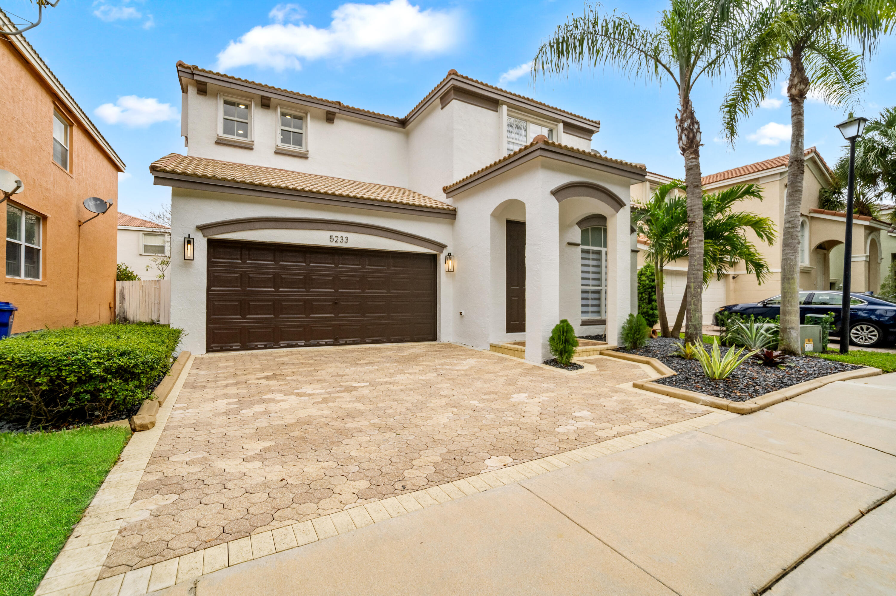 5233 Southwest 155th Way Miramar, FL 33027 - Photo 63 of 63 a view of a white house with a yard and potted plants