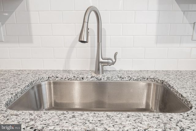 a view of kitchen with sink and stainless steel appliances