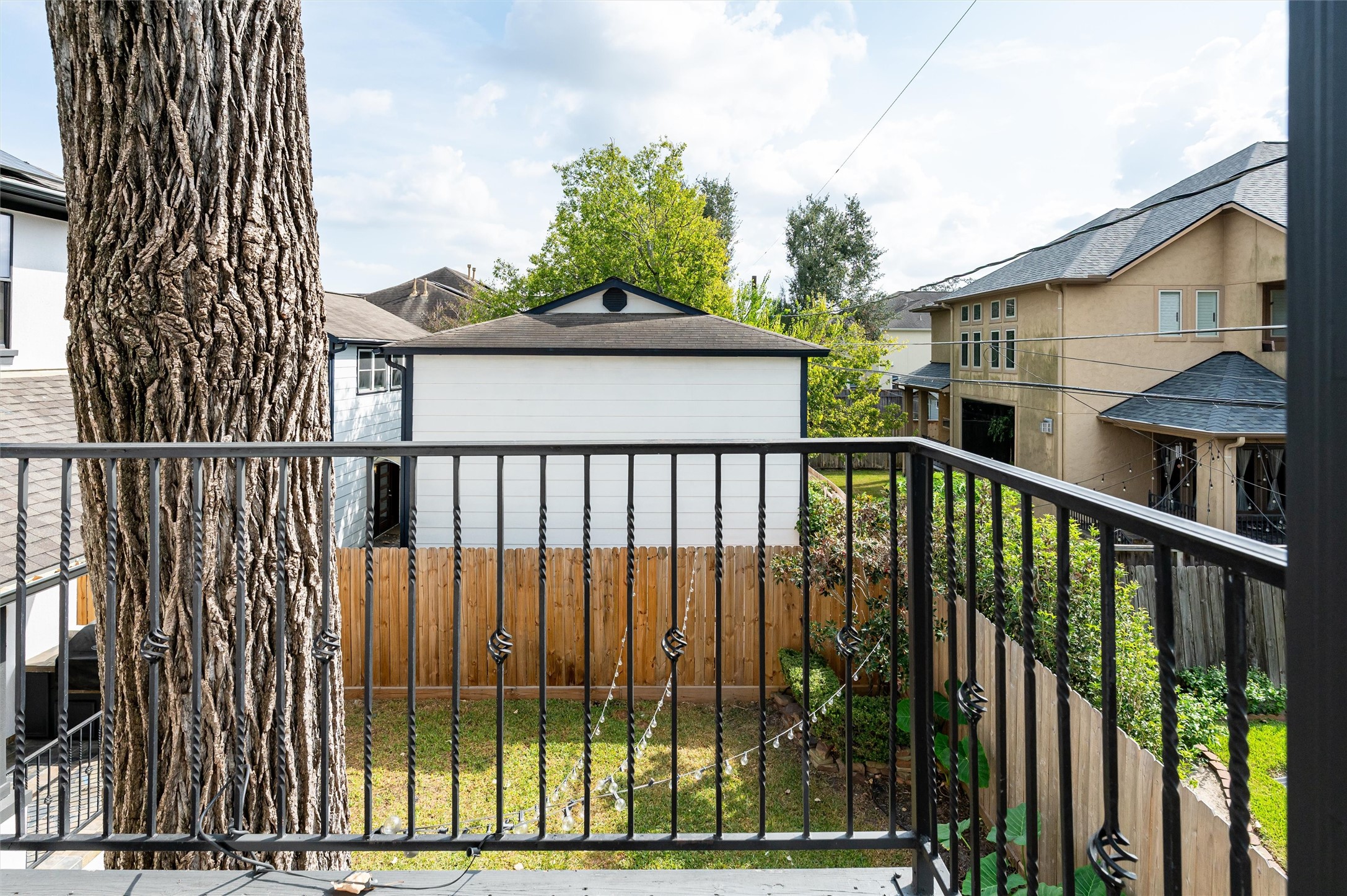4523 Maple Street Bellaire, TX 77401 - Photo 35 of 50 The garage apartment also provides access to a balcony overlooking the backyard, beautifully enclosed with wrought iron railings.